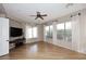 Inviting living room featuring wood floors, bright windows with views, and a ceiling fan at 5405 S Marigold Way, Gilbert, AZ 85298
