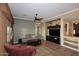 Inviting living area with decorative window treatments and media center at 5405 S Marigold Way, Gilbert, AZ 85298