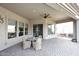 Spacious covered patio with a brick floor, ceiling fan, and outdoor seating at 5405 S Marigold Way, Gilbert, AZ 85298