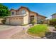 Charming two-story home features neutral stucco, two-car garage, tile roof and lush landscaping at 5527 W Tonopah Dr, Glendale, AZ 85308