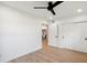 Clean bedroom with hardwood floors, white walls, fan, and closet at 6143 E Lewis Ave, Scottsdale, AZ 85257