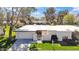 Beautiful single-story home with a well-kept lawn, two-car garage, and gated front entryway at 6143 E Lewis Ave, Scottsdale, AZ 85257