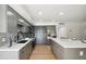 Modern kitchen with sleek gray cabinetry, stainless steel appliances, and a spacious center island at 6143 E Lewis Ave, Scottsdale, AZ 85257