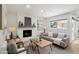 Bright living room featuring a fireplace, comfortable seating, and an abundance of natural light at 6143 E Lewis Ave, Scottsdale, AZ 85257