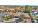 House surrounded by desert landscape has mature trees, water feature, and two-car garage at 6713 N 80Th Pl, Scottsdale, AZ 85250