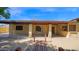 Inviting covered back patio with brick columns, overlooking a gravel yard at 6713 N 80Th Pl, Scottsdale, AZ 85250