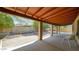 Covered backyard patio featuring a gravel landscape, mature trees, and ample space for outdoor entertaining at 6713 N 80Th Pl, Scottsdale, AZ 85250