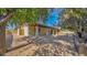 A covered patio with brick columns is surrounded by a rock landscaped yard at 6713 N 80Th Pl, Scottsdale, AZ 85250