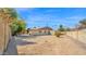 Spacious gravel backyard with block fence, desert landscaping, and small storage shed at 6713 N 80Th Pl, Scottsdale, AZ 85250