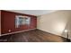 Bedroom features wood floor, accent wall, window with blinds and lamp at 6713 N 80Th Pl, Scottsdale, AZ 85250