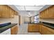 Stylish eat-in kitchen with warm wood cabinetry, tile floors, and ample counter space for meal preparation at 6713 N 80Th Pl, Scottsdale, AZ 85250