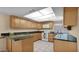 Well-lit kitchen with light wood cabinets, granite countertops, and modern appliances at 6713 N 80Th Pl, Scottsdale, AZ 85250