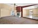 Cozy living room with a brick fireplace, carpeted floors, and views to other rooms at 6713 N 80Th Pl, Scottsdale, AZ 85250