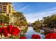Scenic waterfront view of Scottsdale with palm trees and a bridge over the canal at 6713 N 80Th Pl, Scottsdale, AZ 85250