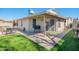 Outdoor backyard with a well-maintained lawn, patio furniture, and desert landscaping at 7018 S 41St Pl, Phoenix, AZ 85042