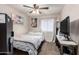 Cozy bedroom featuring a ceiling fan, tropical artwork, and natural light at 7018 S 41St Pl, Phoenix, AZ 85042