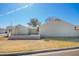 Single-story house featuring a spacious yard, block wall, an open carport and mature trees at 7018 S 41St Pl, Phoenix, AZ 85042