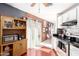 Modern kitchen featuring white cabinets, stainless steel appliances, black countertops, and views of the dining and living area at 7018 S 41St Pl, Phoenix, AZ 85042