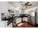 Well-equipped kitchen with sleek black countertops, stainless steel appliances, modern cabinetry, and a stylish backsplash at 7018 S 41St Pl, Phoenix, AZ 85042