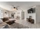 Open-concept living area with tile flooring, a comfortable sofa, modern furnishings, and a dining area at 7018 S 41St Pl, Phoenix, AZ 85042