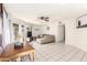 Bright open-concept living room featuring tile floors, a cozy sofa, and a dining area at 7018 S 41St Pl, Phoenix, AZ 85042