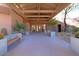 Covered entrance has concrete benches, flower planters and a stone walkway leading to the front doors at 7019 E Thirsty Cactus Ln, Scottsdale, AZ 85266