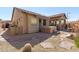 Backyard view with a covered patio, stone accents, hot tub and low maintenance desert landscaping at 7232 E Nance St, Mesa, AZ 85207