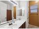 Bathroom featuring a vanity, tile floors, mirror, shower with curtain, and window for natural light at 7232 E Nance St, Mesa, AZ 85207
