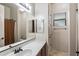 Full bath with a single sink, wood cabinets, tile floors, and bathtub with shower at 7232 E Nance St, Mesa, AZ 85207
