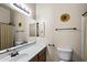 Bathroom with a single sink, wood cabinets, tile floors, bathtub with shower, and a mirror at 7232 E Nance St, Mesa, AZ 85207