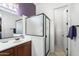 Well-lit bathroom features a framed glass shower, vanity, and sink with tile flooring at 7232 E Nance St, Mesa, AZ 85207
