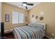 Bedroom with a fan, natural light from the window, and hardwood floors at 7232 E Nance St, Mesa, AZ 85207