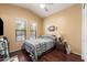 Bedroom featuring hardwood floors, blinds on the windows, and neutral colored walls at 7232 E Nance St, Mesa, AZ 85207