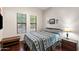 Bedroom with a large window, wood floors, and a comfortable queen-sized bed at 7232 E Nance St, Mesa, AZ 85207