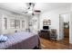 Bright bedroom with wood floors, ceiling fan and large window, creating an inviting space at 7232 E Nance St, Mesa, AZ 85207
