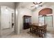 Well-lit dining room features a traditional china cabinet and views into the entry hall at 7232 E Nance St, Mesa, AZ 85207
