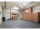 Spacious garage with epoxy flooring, storage cabinets and ample room for vehicles and other storage at 7232 E Nance St, Mesa, AZ 85207