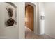 Inviting hallway with an arched alcove and neutral tile floors, showcasing the home's elegant design at 7232 E Nance St, Mesa, AZ 85207