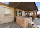 Outdoor hot tub on a paver patio, featuring an awning for shade and privacy at 7232 E Nance St, Mesa, AZ 85207