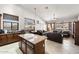 Spacious kitchen island that overlooks a cozy living room and eat-in area, blending living spaces at 7232 E Nance St, Mesa, AZ 85207