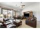 Cozy living room with tile floors, comfortable leather seating, and a sliding door to the patio at 7232 E Nance St, Mesa, AZ 85207