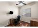 Home office with wood floors, ceiling fan, large window, and desk with chair at 7232 E Nance St, Mesa, AZ 85207