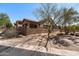A tan, upscale home with desert landscaping and a tile roof at 7232 E Nance St, Mesa, AZ 85207