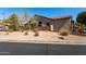 Tan home on a corner lot with desert landscaping, and a tile roof in an upscale community at 7232 E Nance St, Mesa, AZ 85207