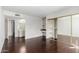 The bedroom features a mirrored closet, a makeup station and dark floors at 7777 E Main St # 258, Scottsdale, AZ 85251