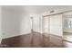 Bedroom with dark wood floors and mirrored closet, providing ample storage space and style at 7777 E Main St # 258, Scottsdale, AZ 85251