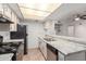 Bright kitchen features white cabinets, stainless steel appliances, and a breakfast bar for casual dining at 7777 E Main St # 258, Scottsdale, AZ 85251