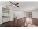 Spacious living room with a bar area, hardwood floors, neutral walls, and natural light from the sliding door at 7777 E Main St # 258, Scottsdale, AZ 85251