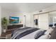 Comfortable main bedroom with TV, closet and soothing color palette for a serene atmosphere at 7777 E Main St # 258, Scottsdale, AZ 85251