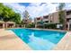 Community pool surrounded by lush landscaping and seating areas, perfect for relaxation and recreation at 7777 E Main St # 258, Scottsdale, AZ 85251